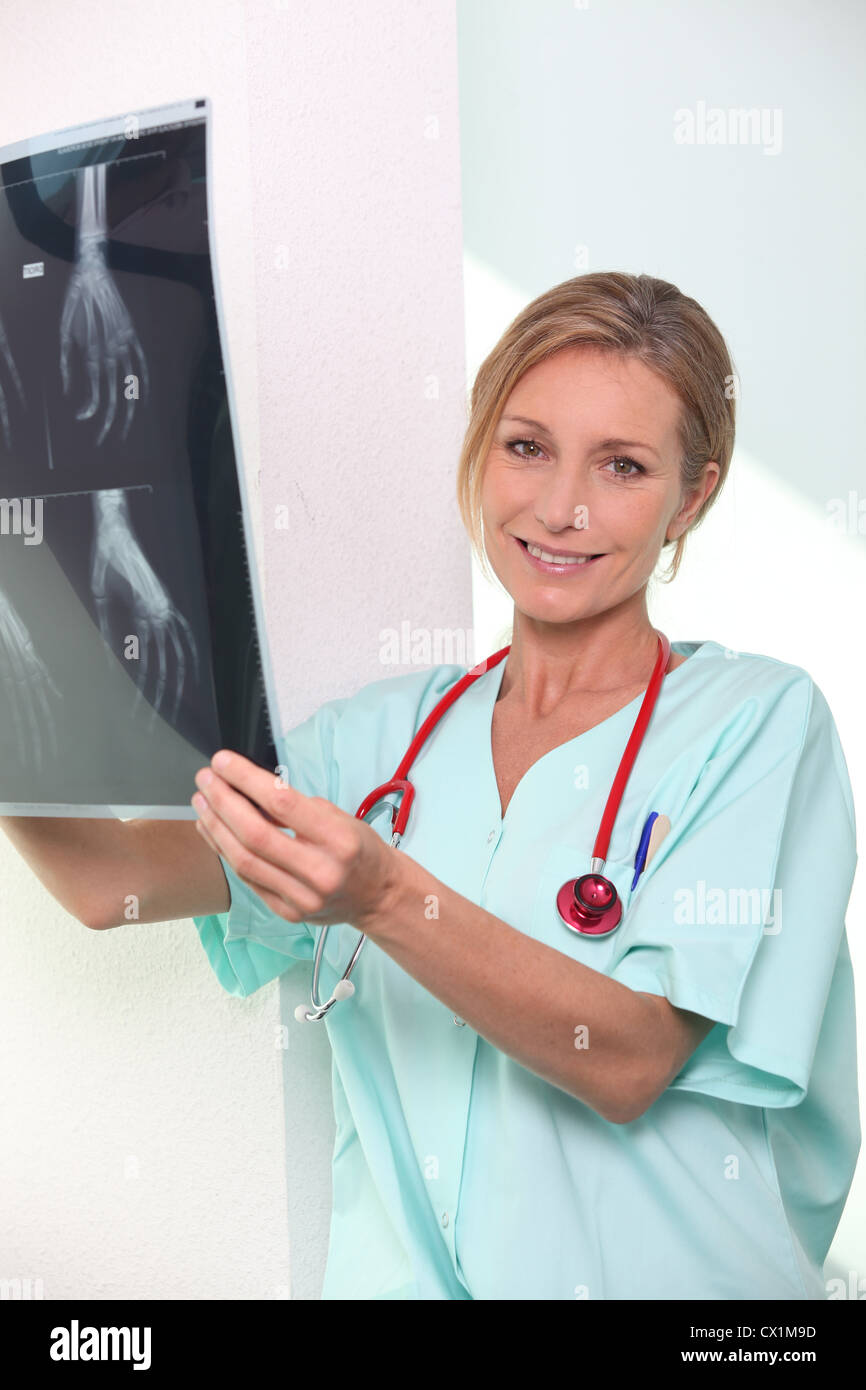 Nurse looking at X-ray Stock Photo
