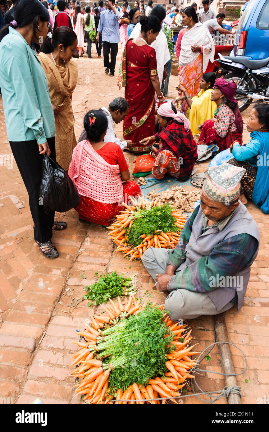 Newari man selling vegetables at Taumadhi Tol square . Bhaktapur , Kathmandu Valley , Nepal Stock Photo