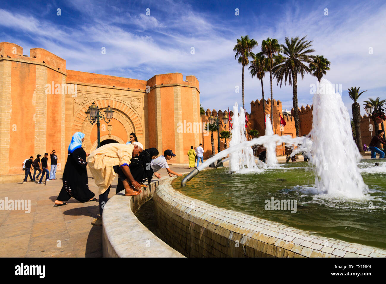 People and fountain by medina walls and Bab el-Had gate. Rabat, Morocco Stock Photo