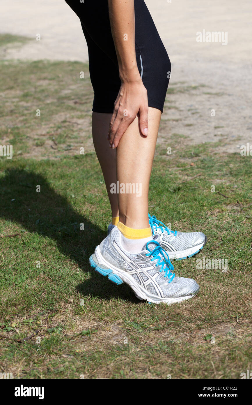 woman having cramp while running Stock Photo Alamy