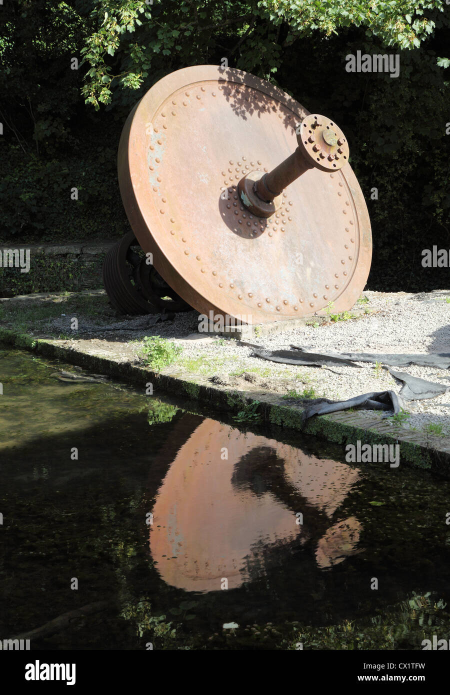 Large flywheel from old steam engine seen within the Greenfield Valley, Holywell, North Wales. Stock Photo