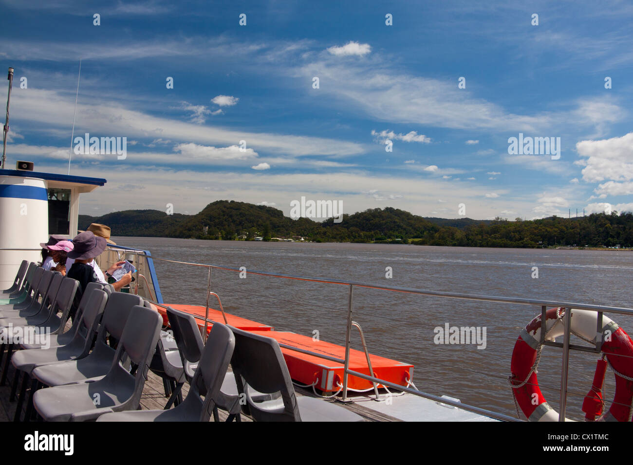 Boat trip on the Hawkesbury Riverboat Postman, with family reading and looking at scenery New South Wales (NSW) Australia Stock Photo