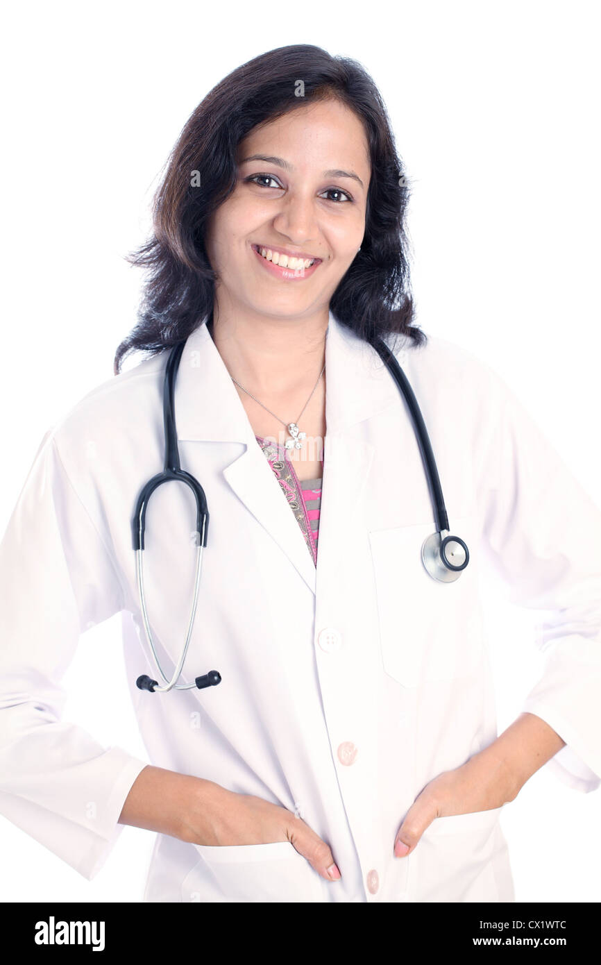 Smiling young Indian female doctor against white background Stock Photo