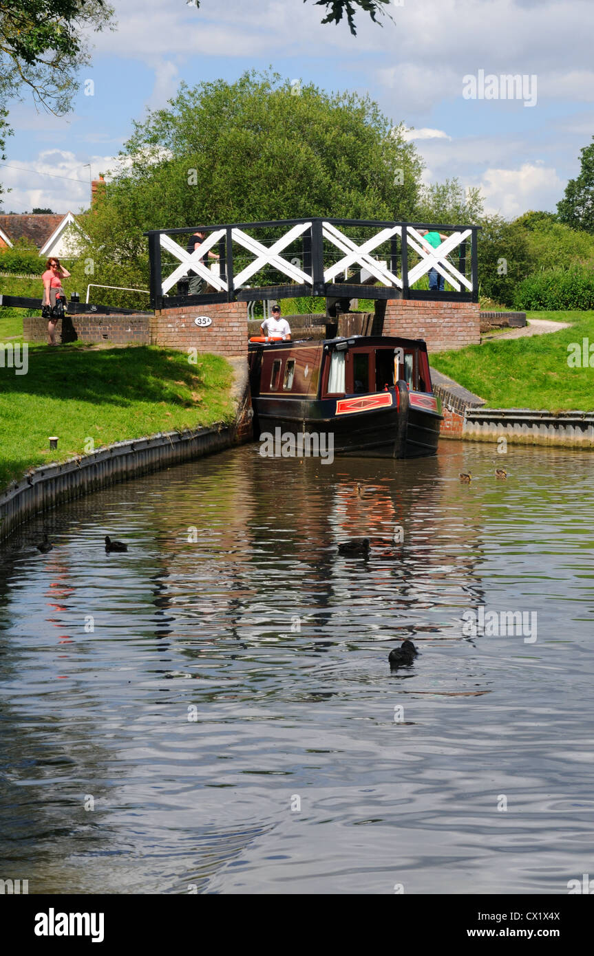 58' narrowboat 'Felicity' emerges from Lock No.19 on the Stratford-upon-Avon Canal near Lapworth, Warwickshire, England Stock Photo