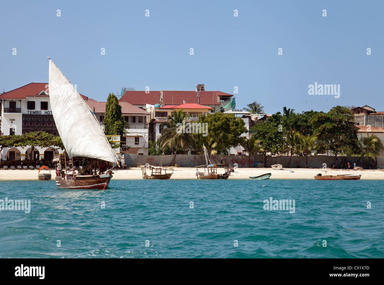 A dhow leaving Stone Town beach, Zanzibar Africa Stock Photo
