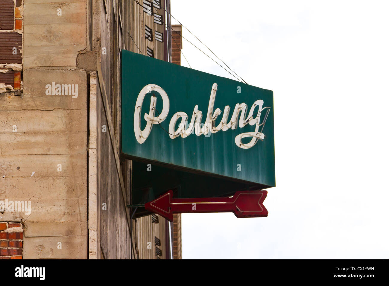 Vintage parking garage sign isolated against white sky background Stock