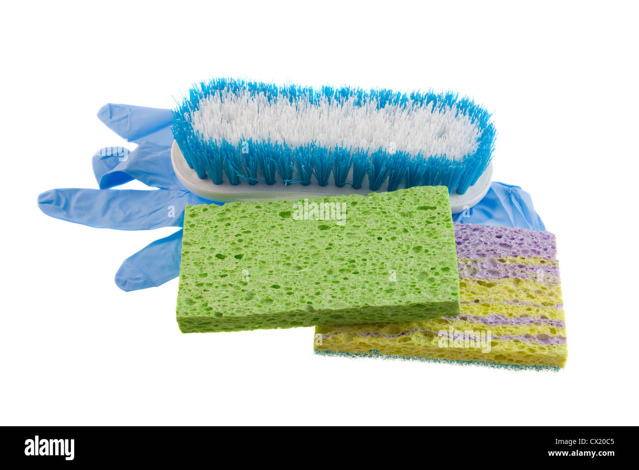 two cleaning sponges, blue and white scrub brush and a disposable glove isolated on white Stock Photo