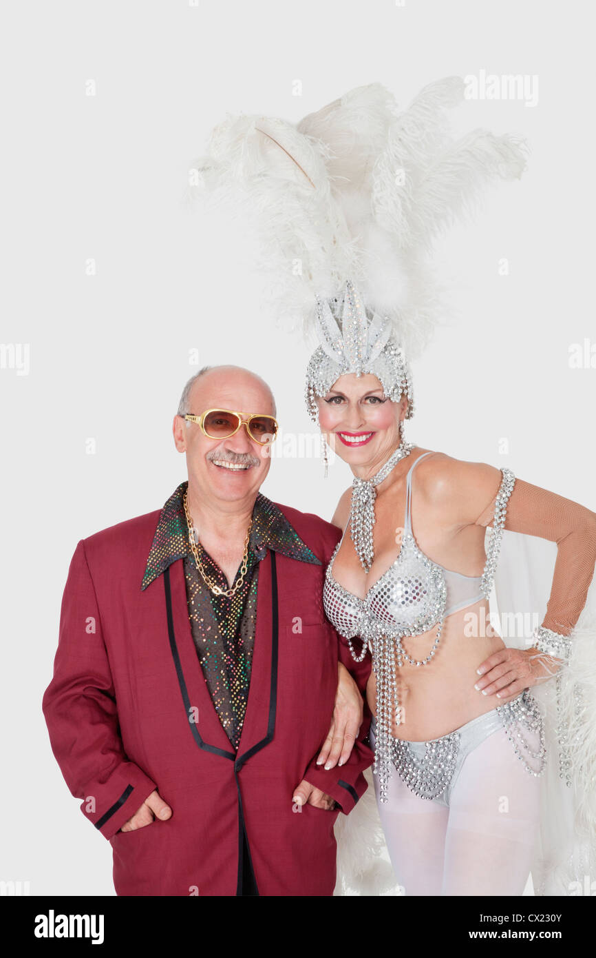 Portrait of man with senior showgirl against gray background Stock Photo