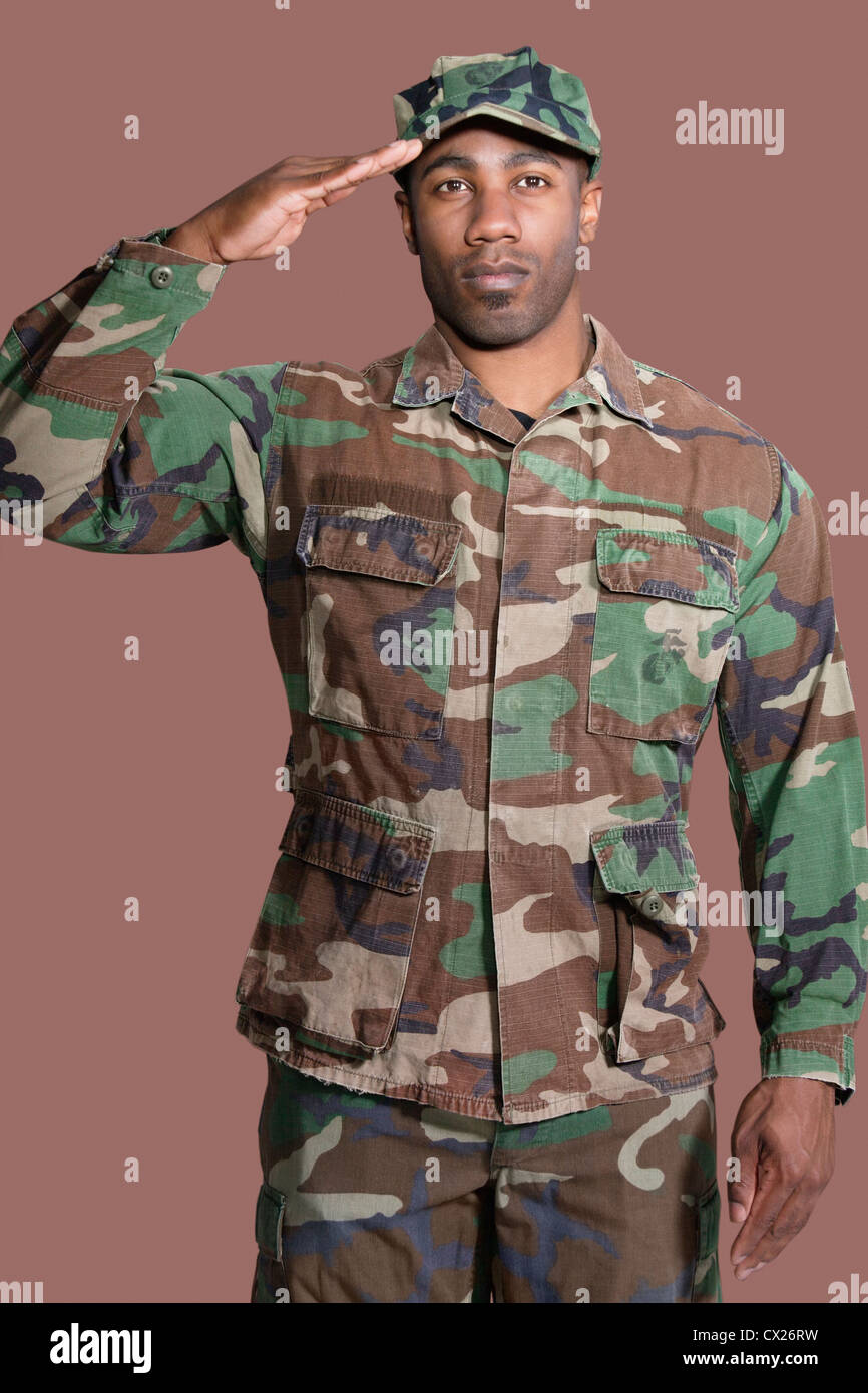 Portrait of a young African American US Marine Corps soldier saluting ...