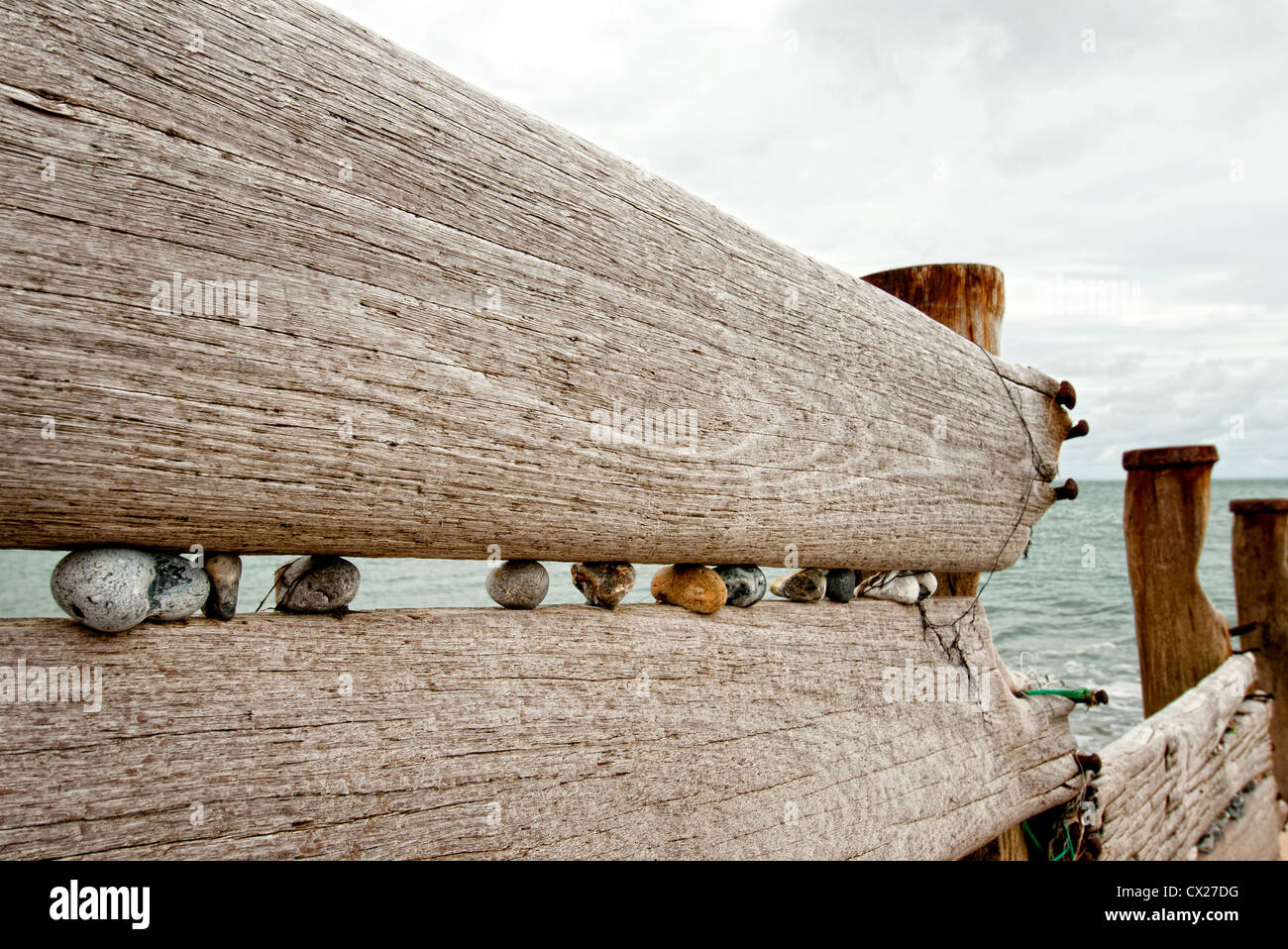 weathered old wooden breakwater groynes sea defence Stock Photo
