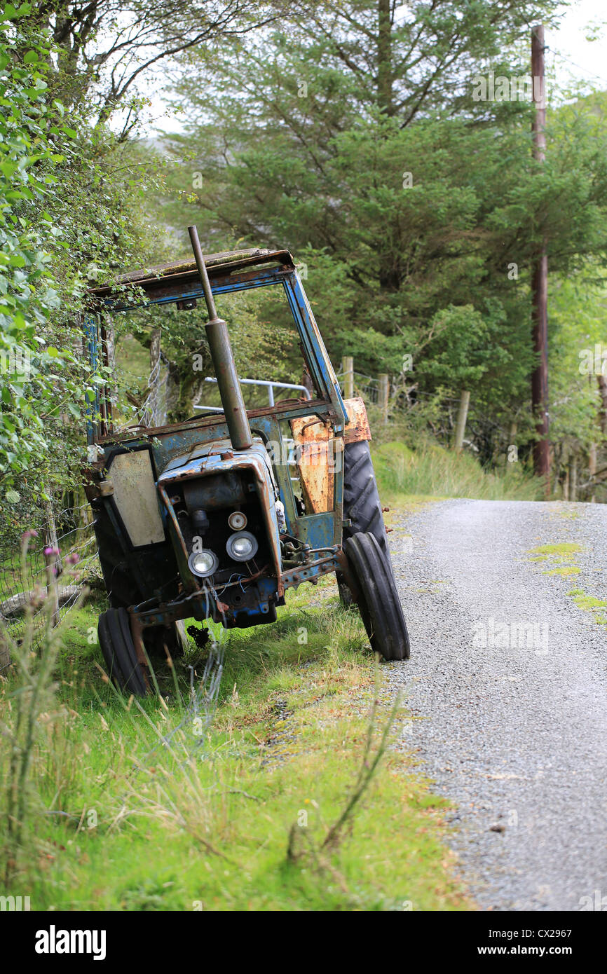 co county kerry, old fordson tractor abandoned on an irish tree lined country lane, Stock Photo