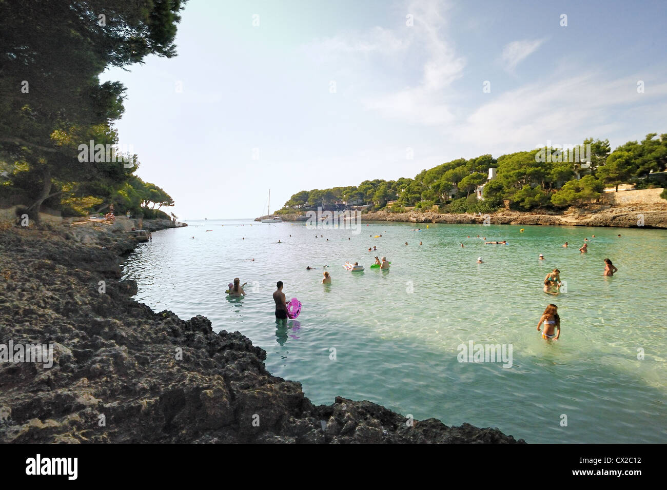 Early swimmers at Cala Gran Beach, Cala D'Or Stock Photo - Alamy