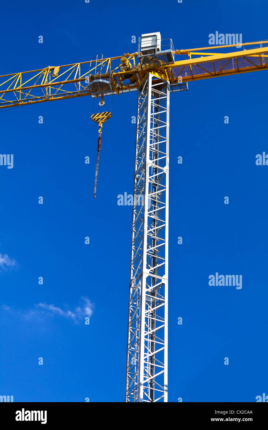 Construction crane against a blue sky with cloud background Stock Photo ...