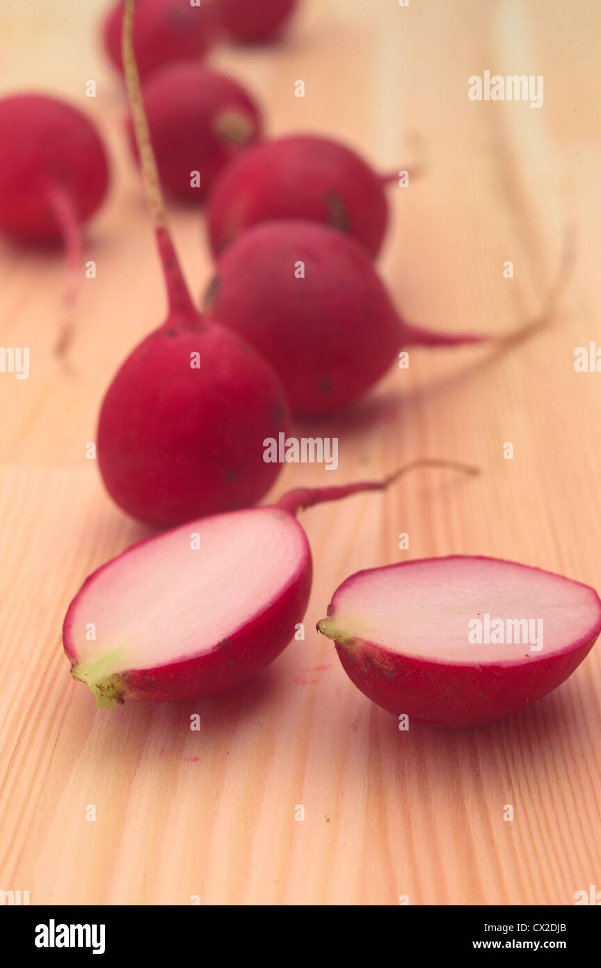 fresh red raw raddish over pine wood table closeup Stock Photo - Alamy