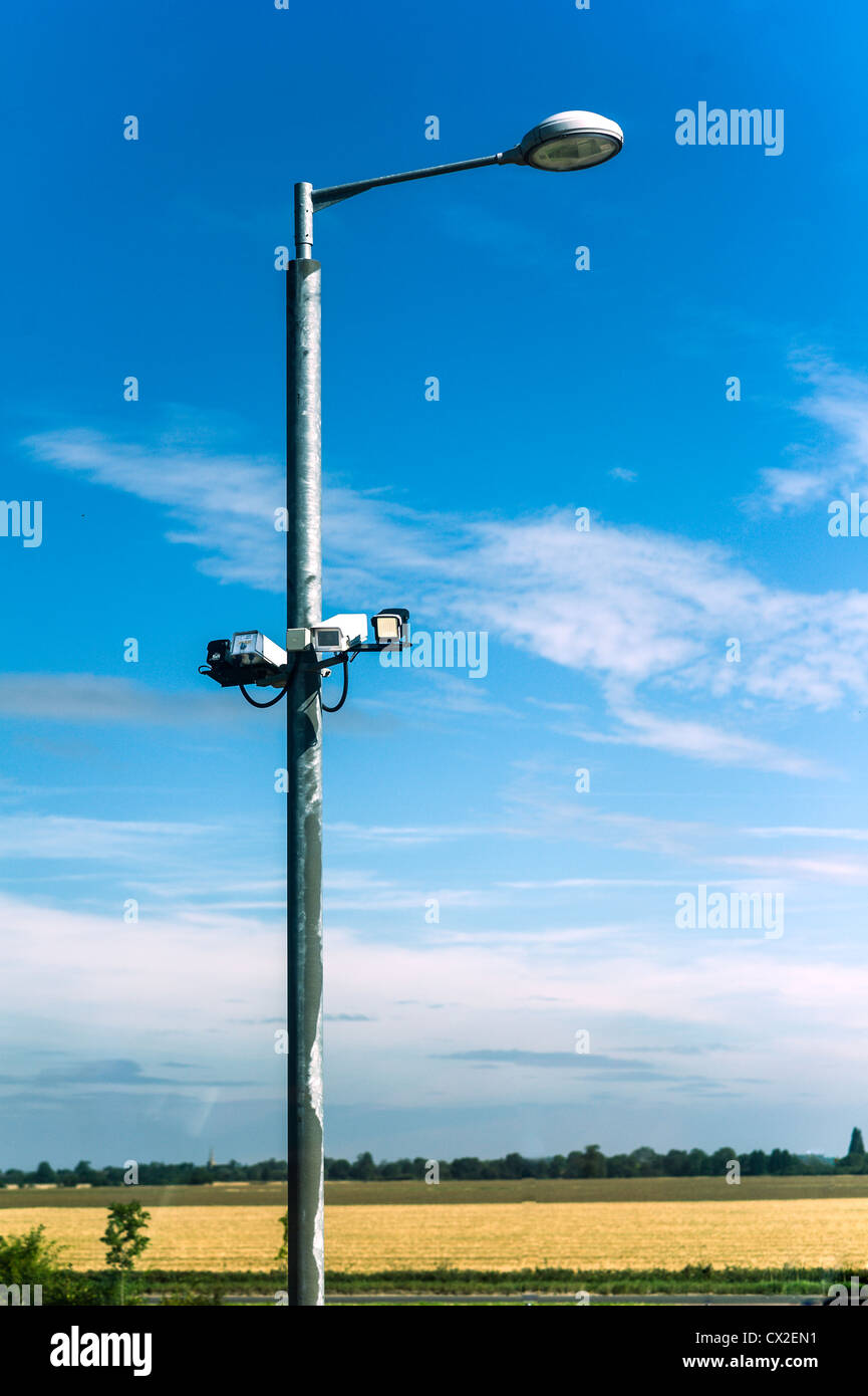 Security cameras on a street light in open countryside Stock Photo Alamy
