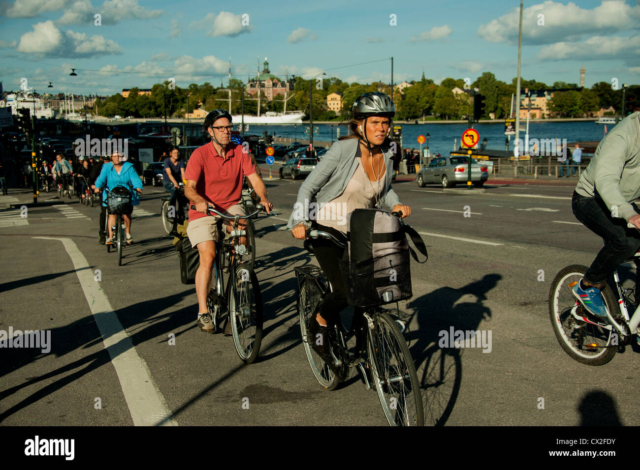 Communters on bicycles passing Gamla Stan The Old Town and Slussen In Stockholm Stock Photo