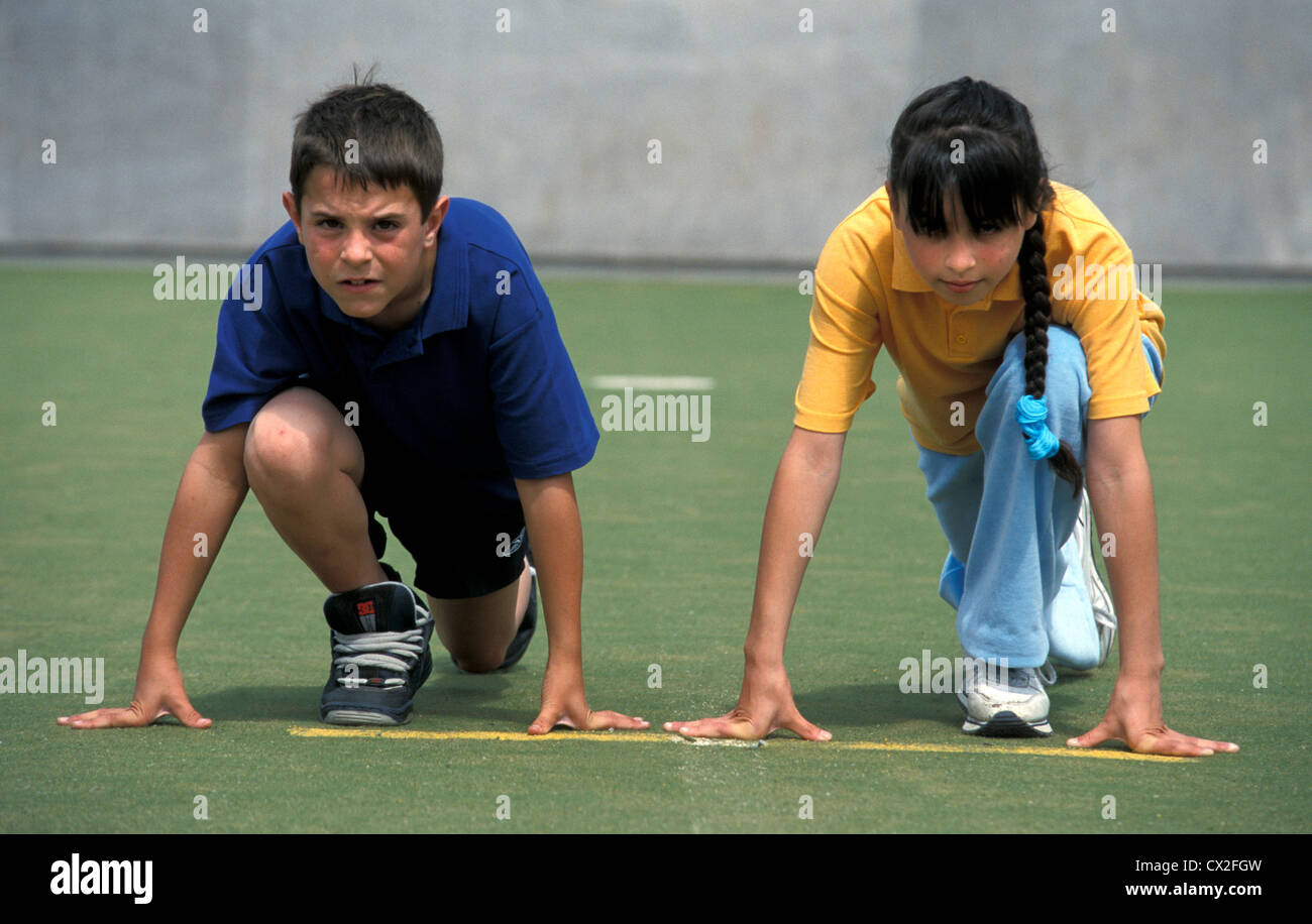 Boy and Girl, ready for start of race at school sports day, UK Stock Photo