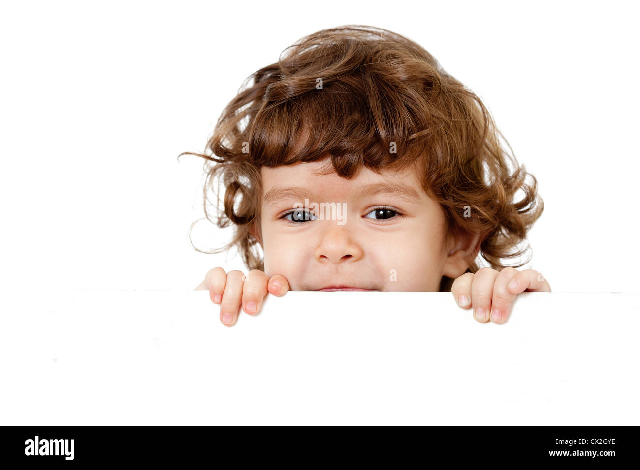Curly funny child face holding blank advertising banner Stock Photo