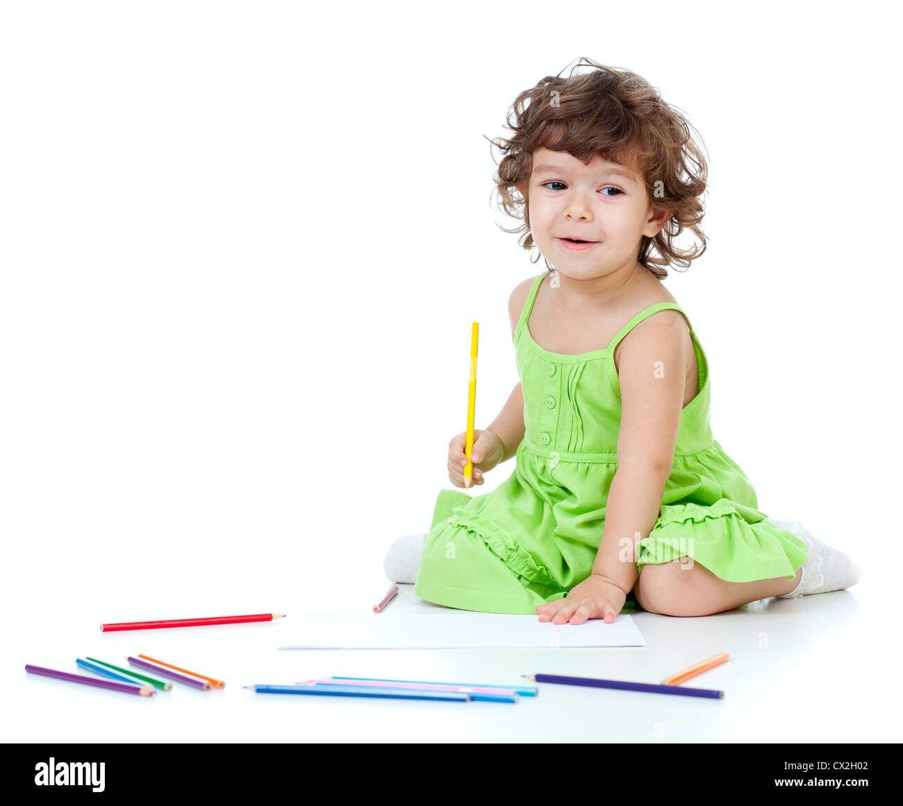 Little girl drawing with yellow pencil Stock Photo