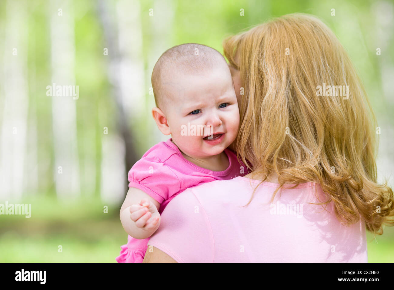 Crying or upset girl with mother outdoor Stock Photo