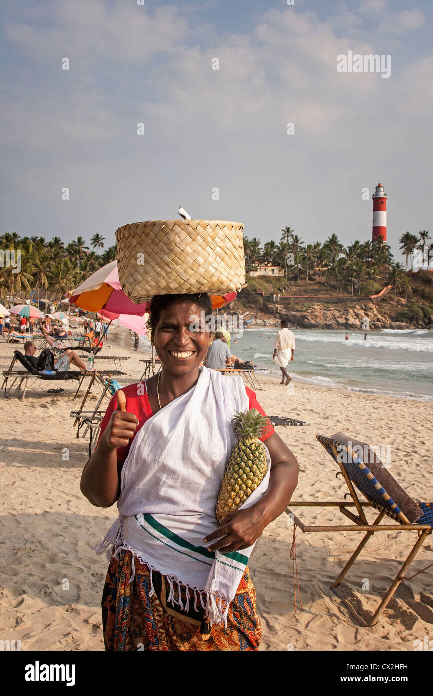 Kovallam beach, women selling pinapple, lighthouse, India Kerala Stock Photo