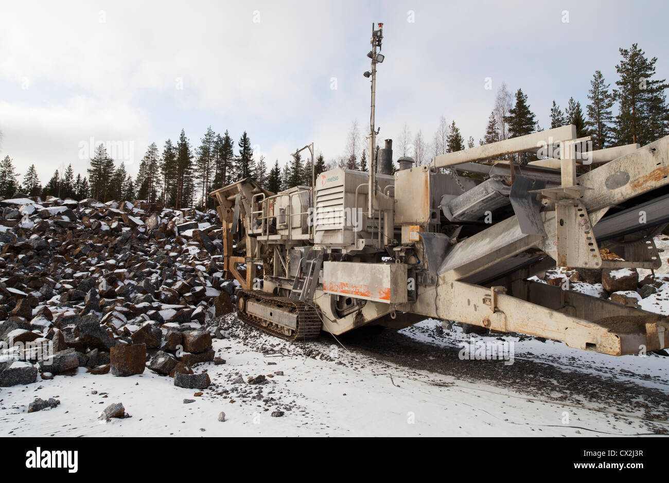 Mobile rock crushing machine at a rock quarry. Crushes stones to