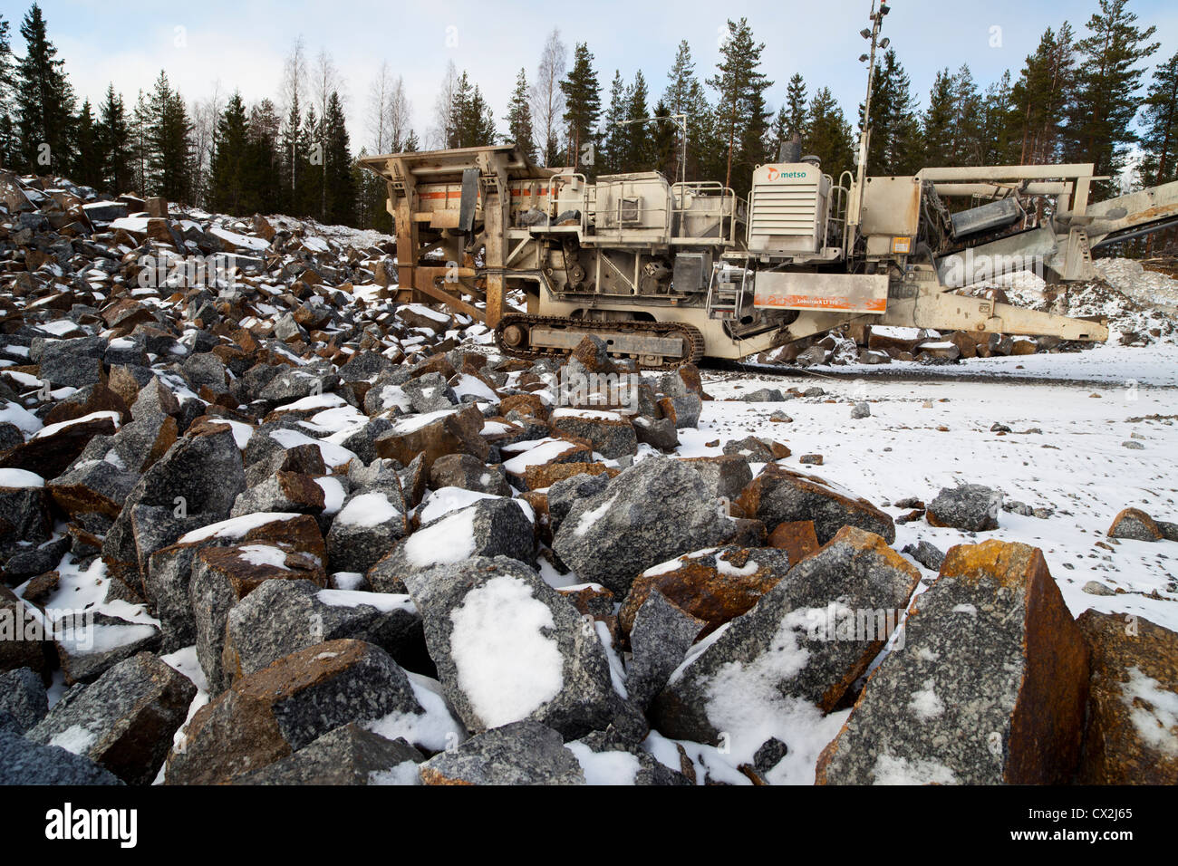 Mobile rock crushing machine at a rock quarry. Crushes stones to