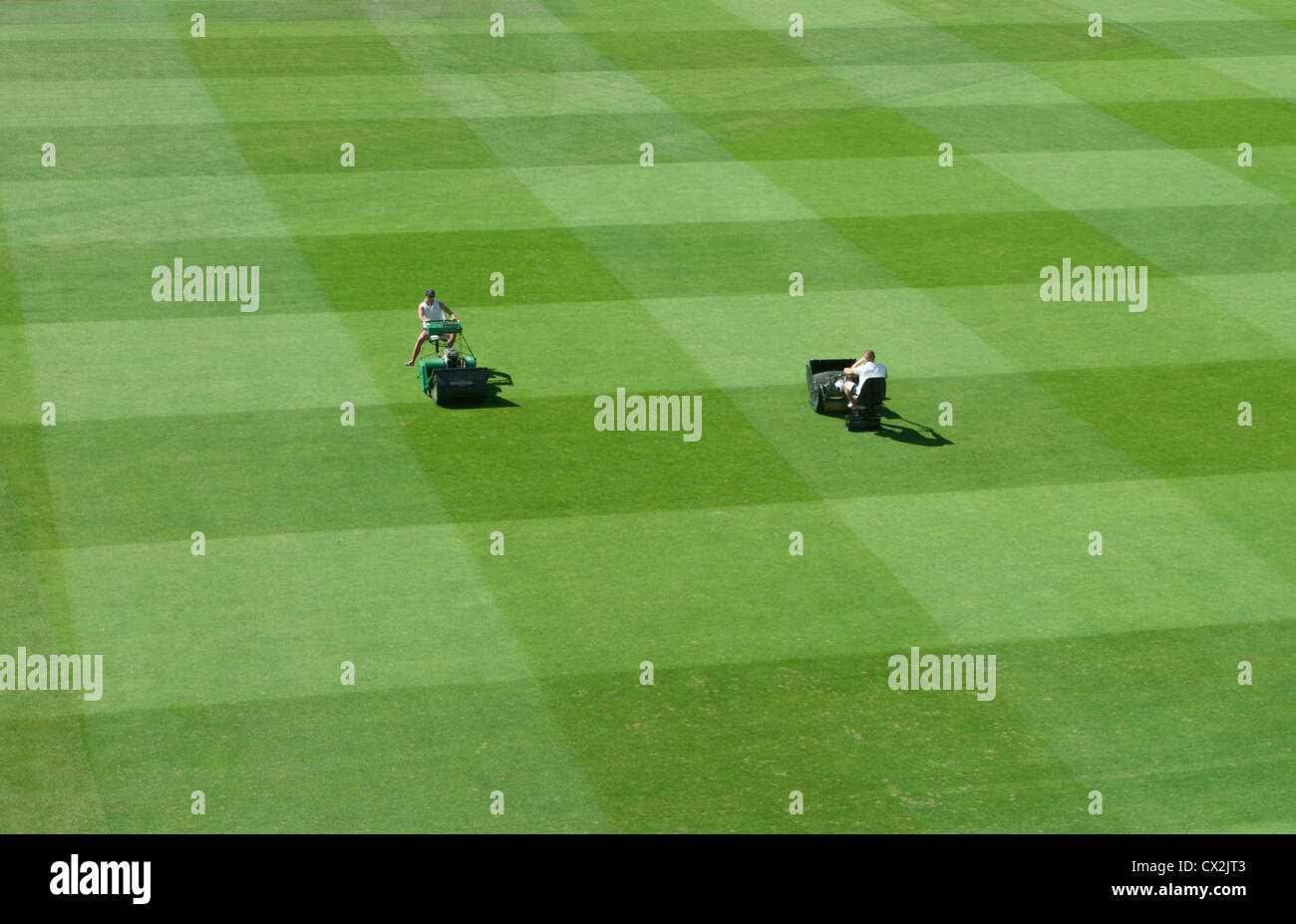Two ground staff mow the pitch at Lord's Cricket ground, London, United