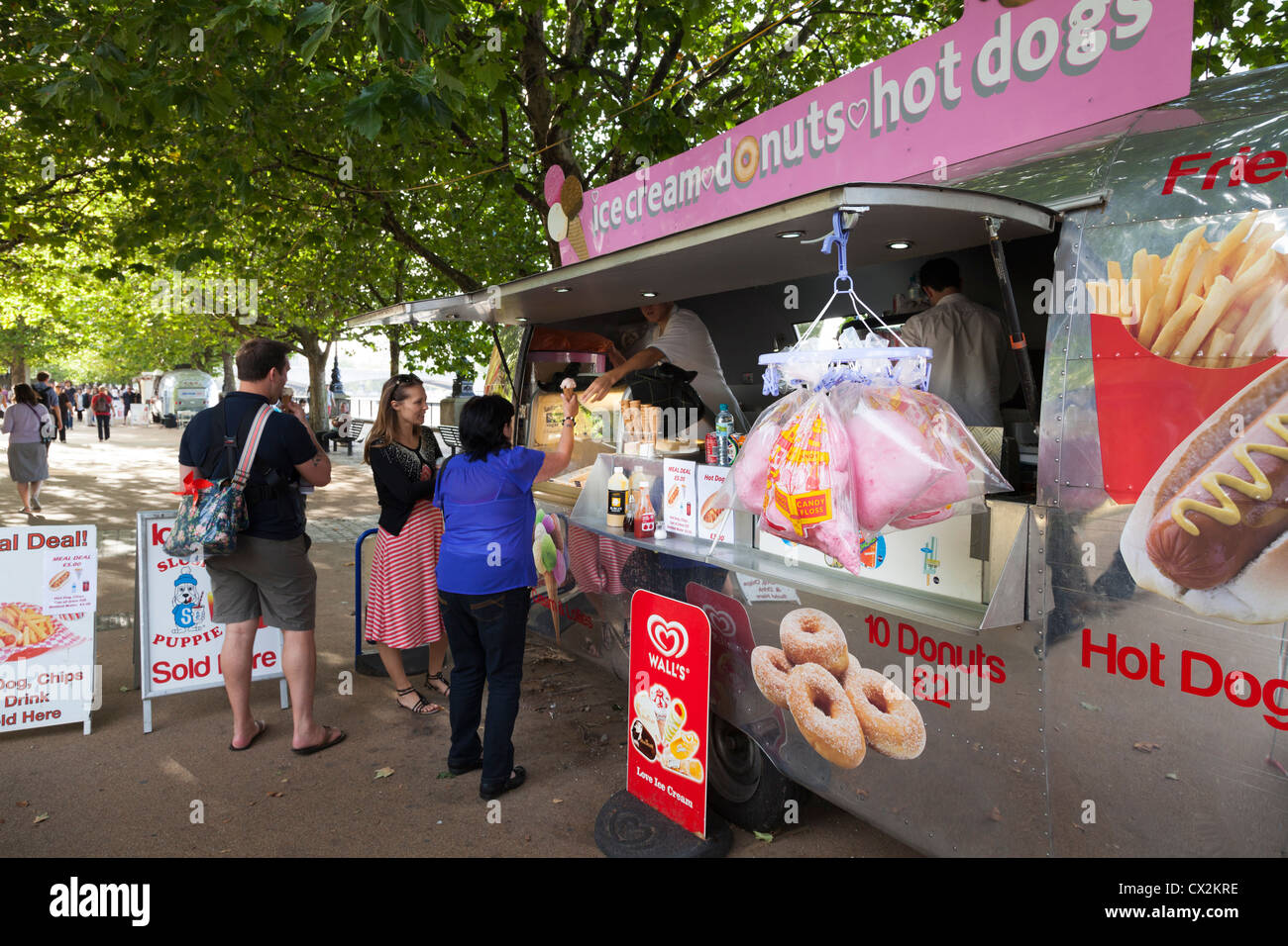 ice cream and donut van under the trees on the south bank of the thames  in london Stock Photo
