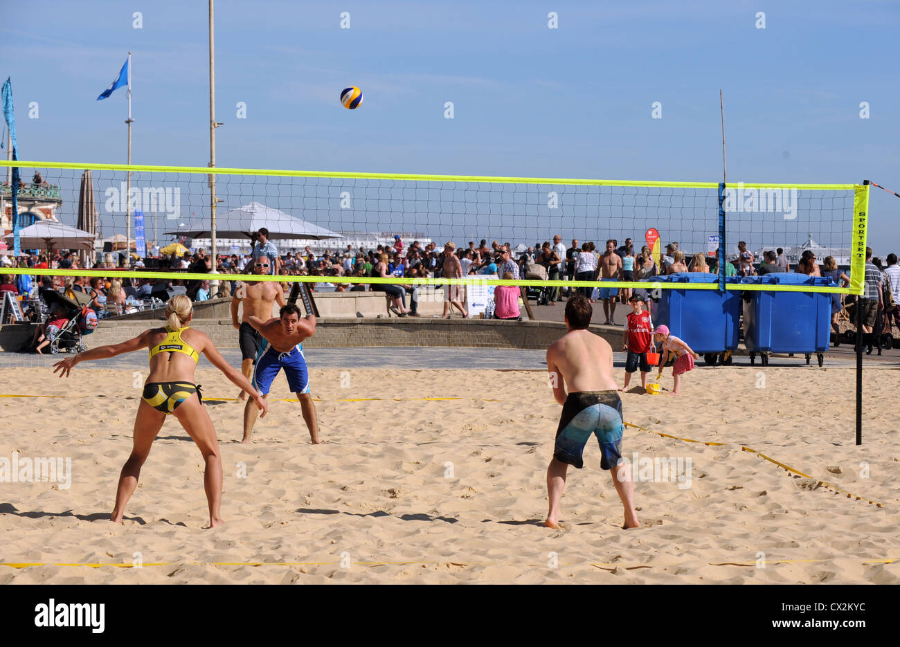 Playing beach volleyball on Brighton seafront UK Stock Photo