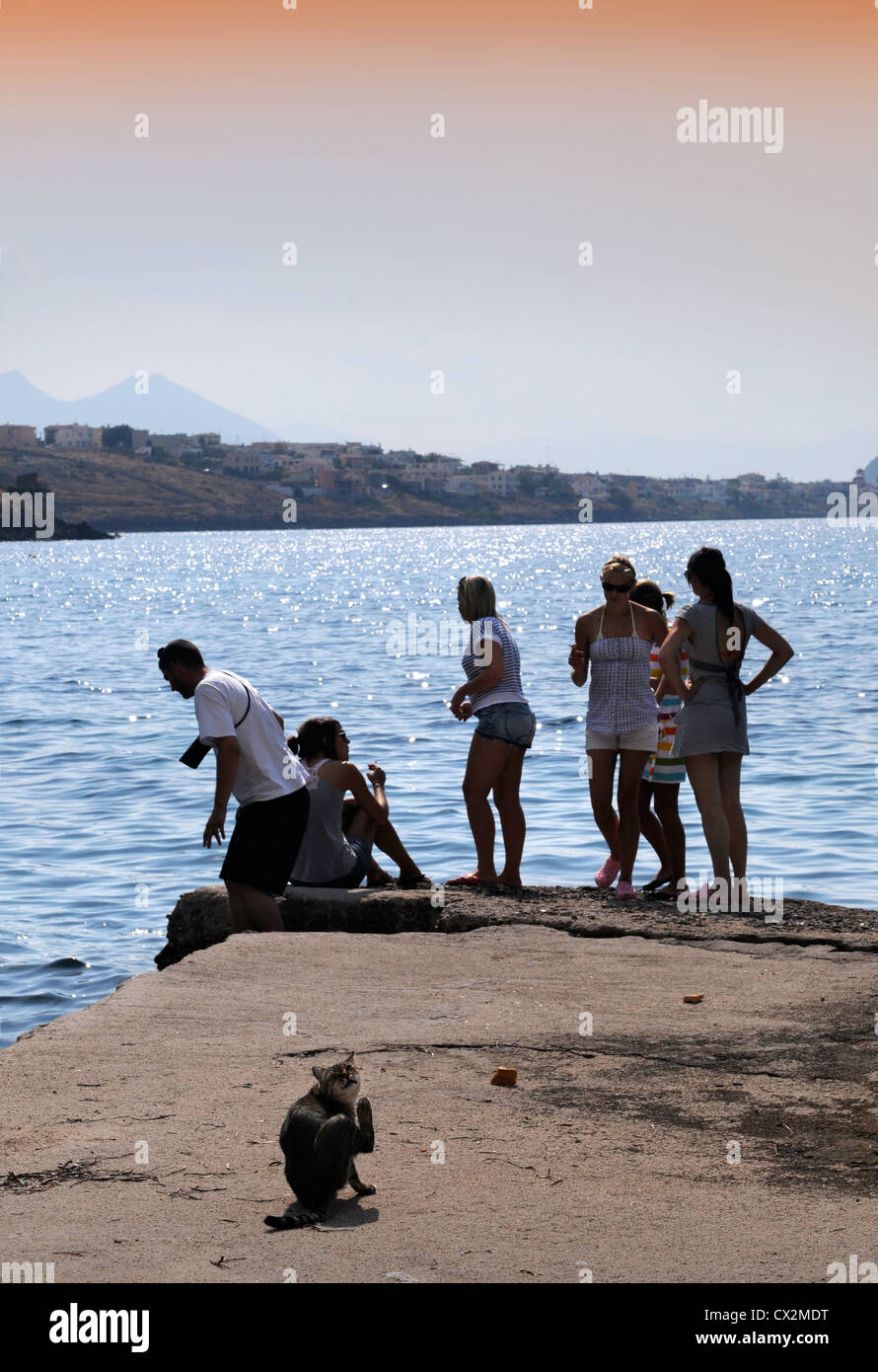 Teenagers on a pier near Marathonas on the island of Aegina Greece Stock Photo