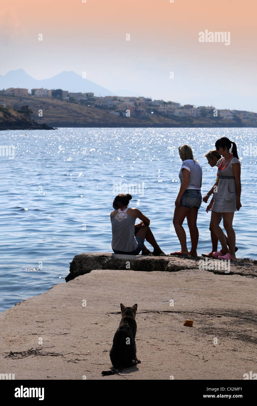 Teenagers on a pier near Marathonas on the island of Aegina Greece Stock Photo