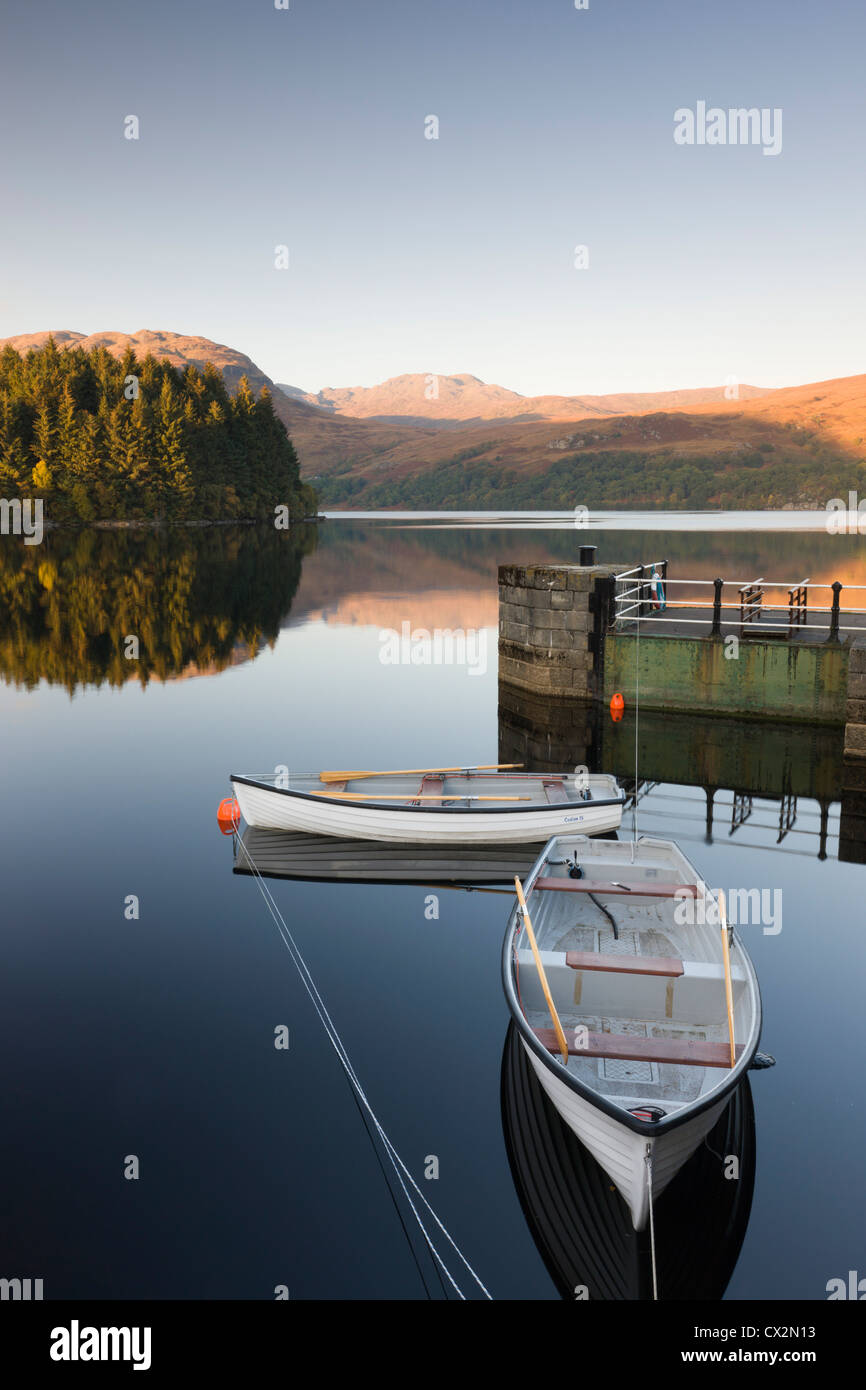 Rowing boats moored on Loch Katrine at Stronachlachar, Stirling, Scotland. Autumn (October) 2010. Stock Photo