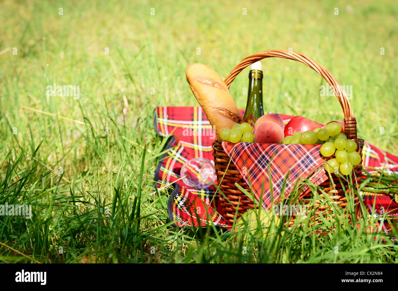 Picnic basket with red napkin fool of fruits, bread and wine Stock ...
