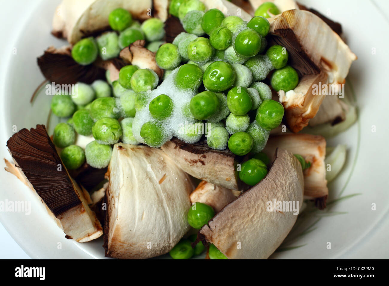 Ingredients for a stir fry mushrooms, onions, and peas Stock Photo