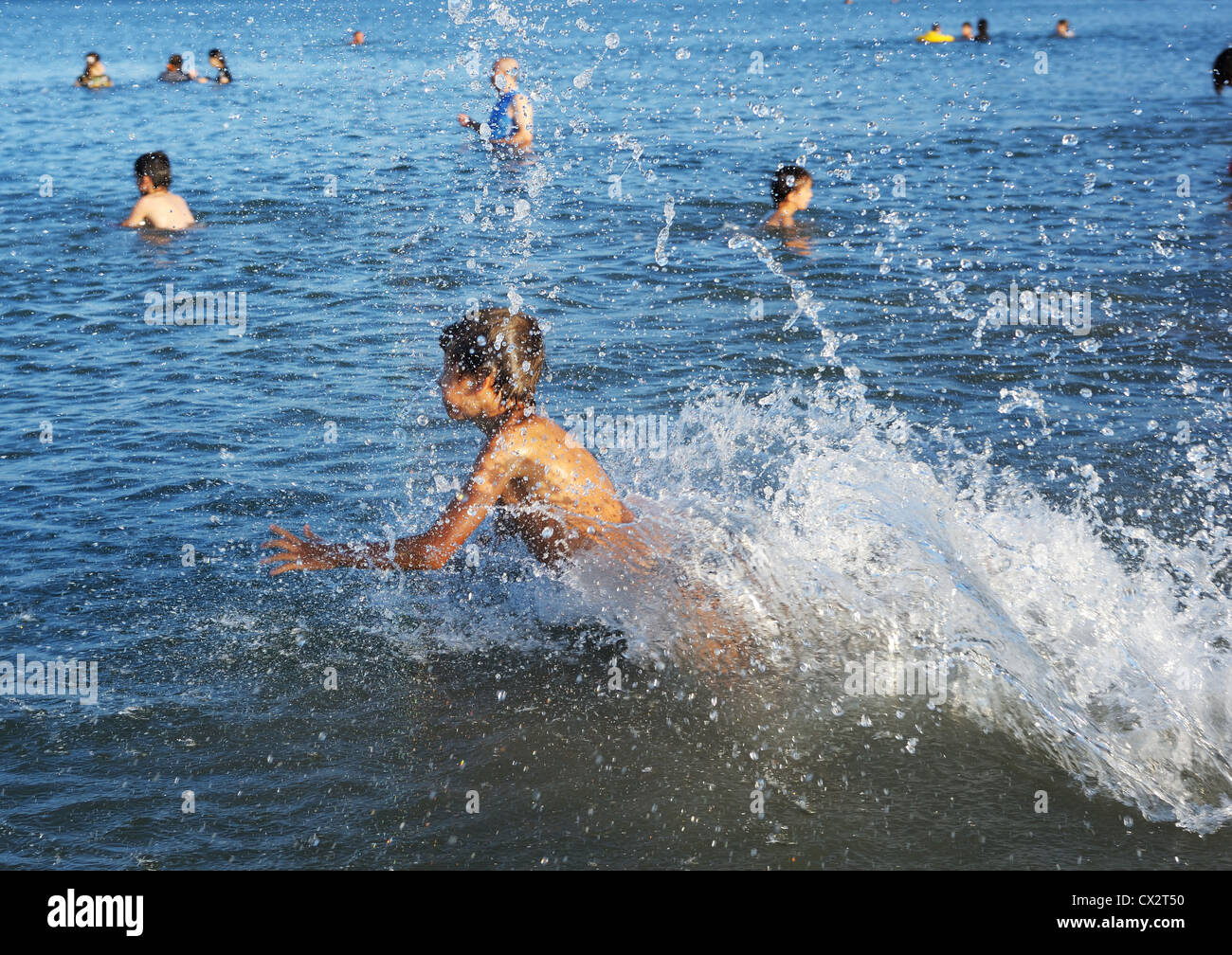 A boy plays in the warm water of lake Kinneret  Stock Photo