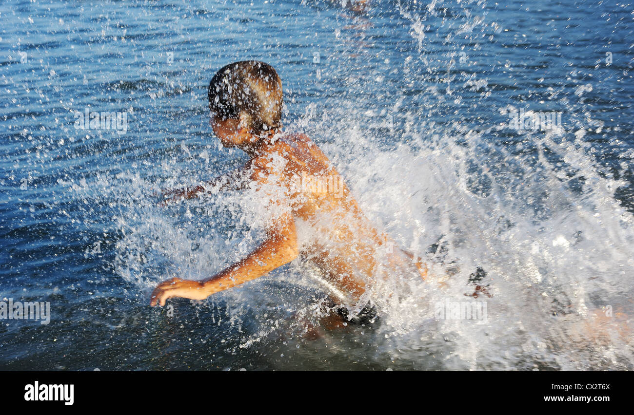 A boy plays in the warm water of lake Kinneret  Stock Photo