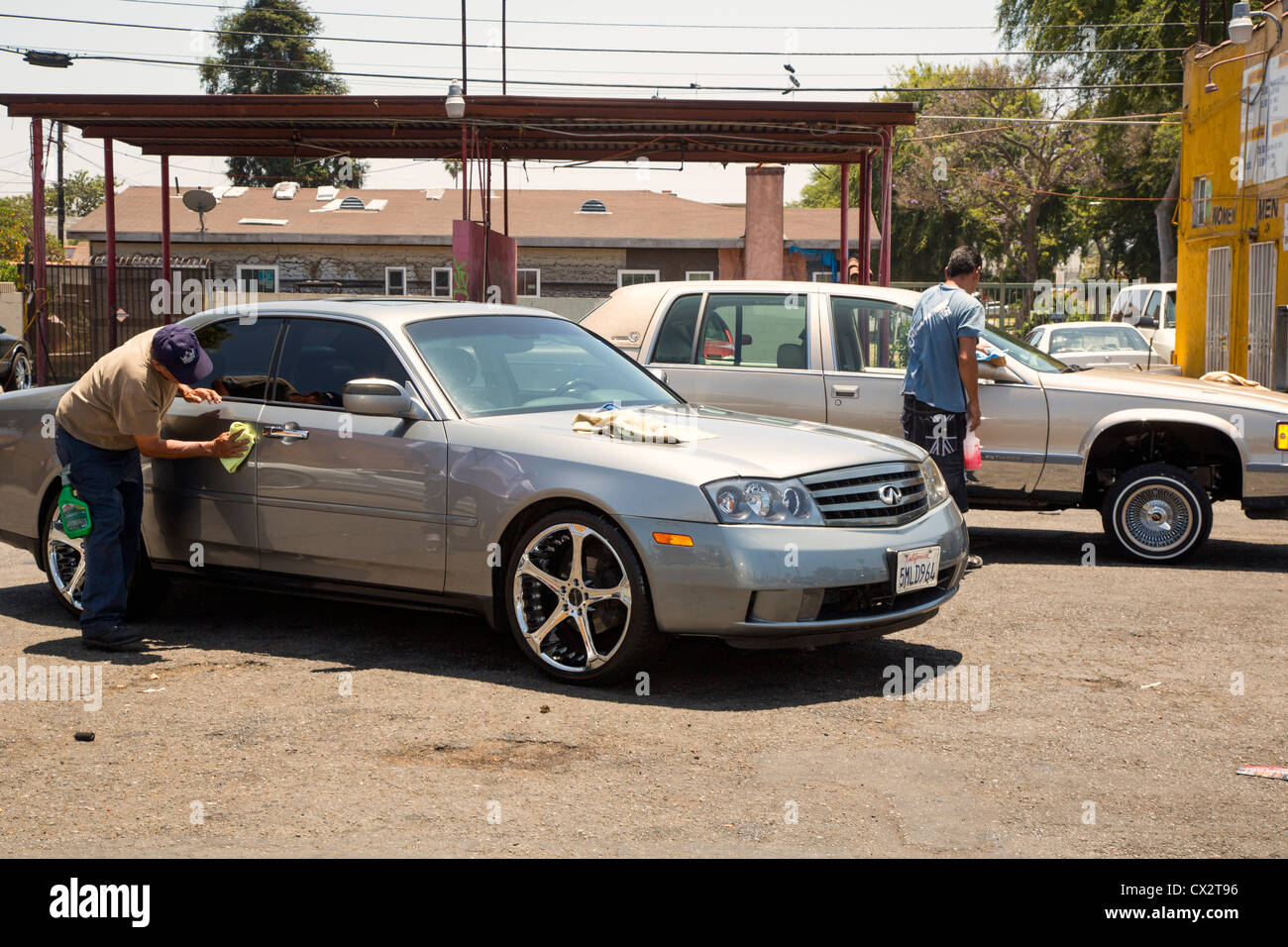 A worker at a car wash in south Los Angeles. Stock Photo