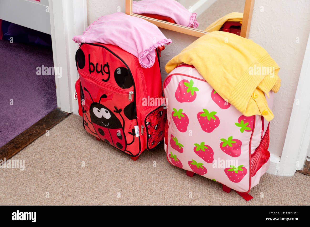 Children's suitcases packed for a holiday sleepover. Stock Photo