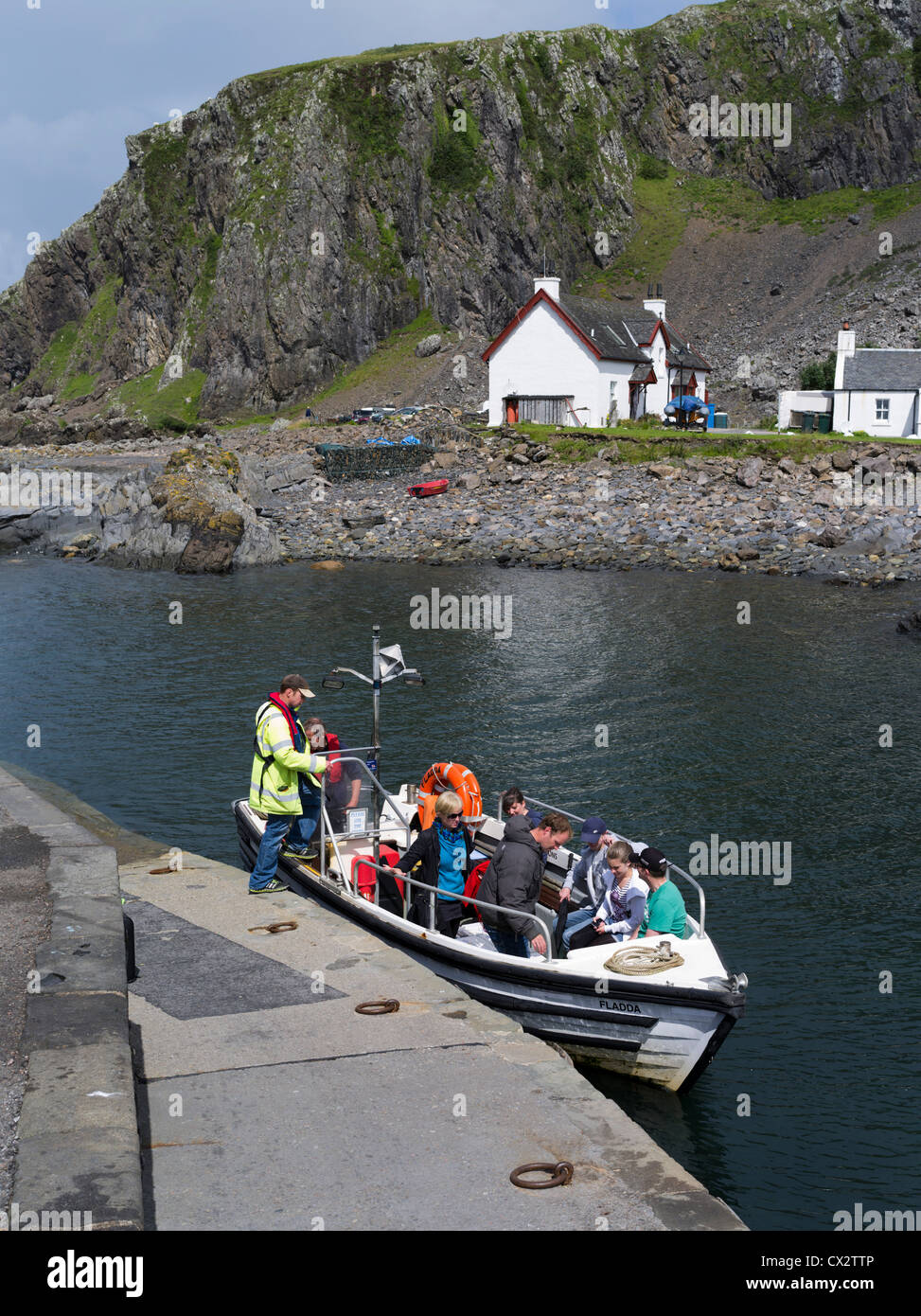dh Easdale ferry boat SEIL ISLAND ARGYLL Scotland People tourists loading on jetty scottish highlands Ellenabeich tourist visiting harbour Stock Photo