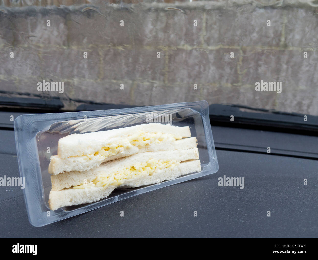 Cheese sandwich in packet on car dashboard Stock Photo Alamy