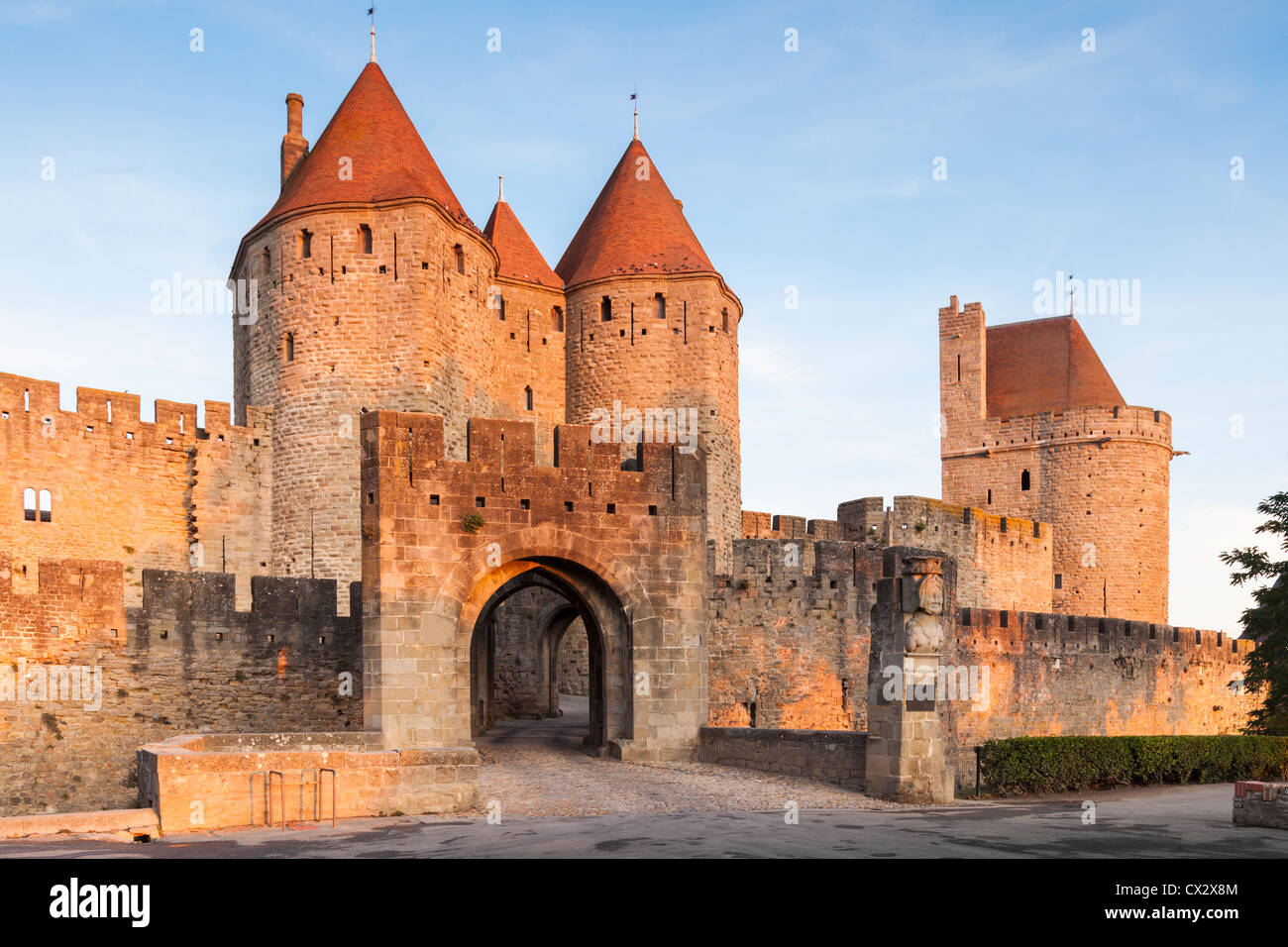 The Porte Narbonnaise, the main entrance to the ancient fortified city of  Carcassonne, illuminated by early morning sunlight Stock Photo - Alamy