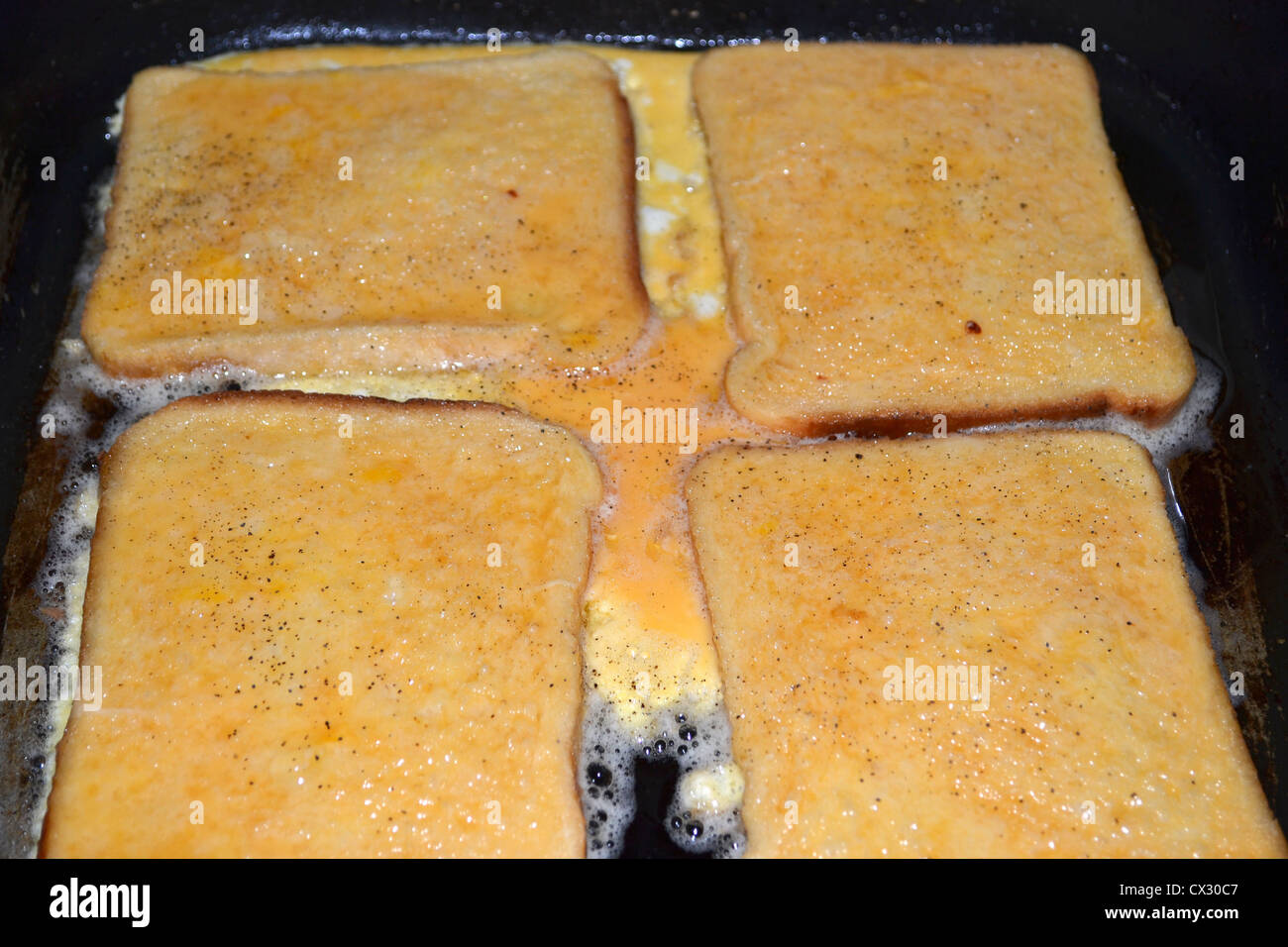 French toast or eggy bread cooking in frypan Stock Photo Alamy
