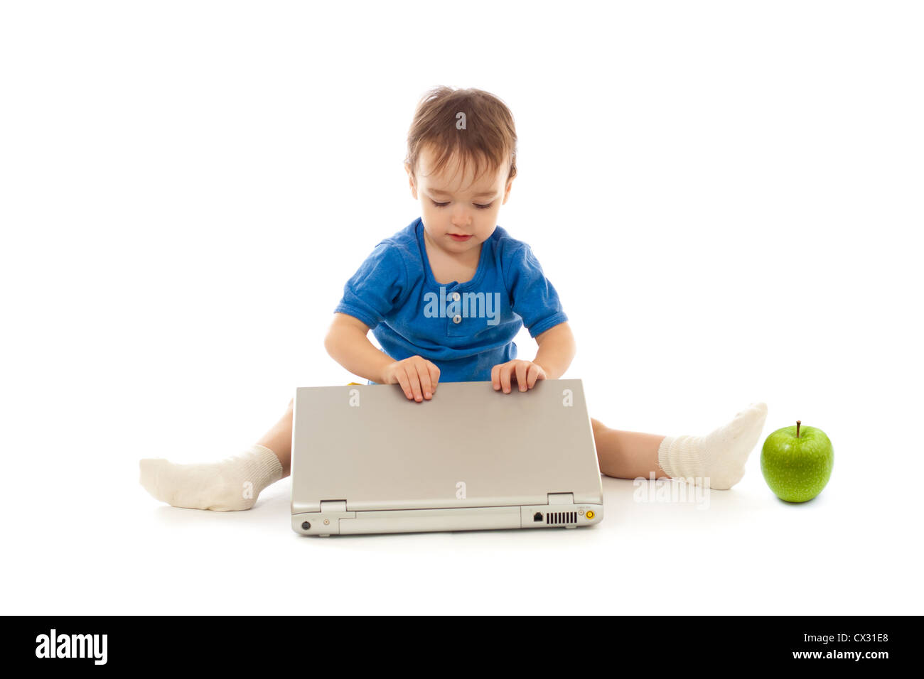 Toddler is using notebook isolated on white Stock Photo