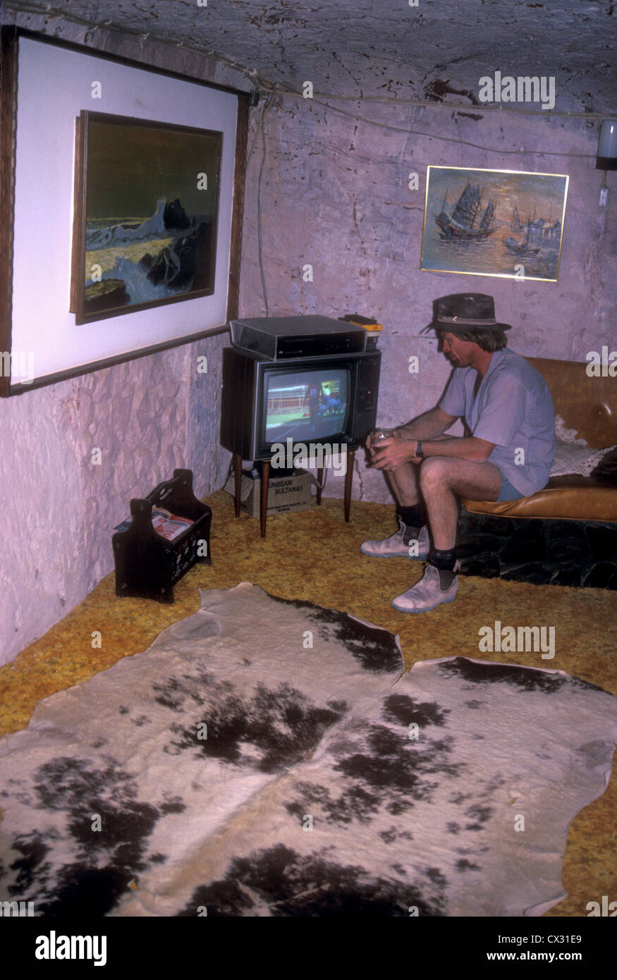 Miner watching TV in an underground house in Coober Pedy Australia Stock Photo