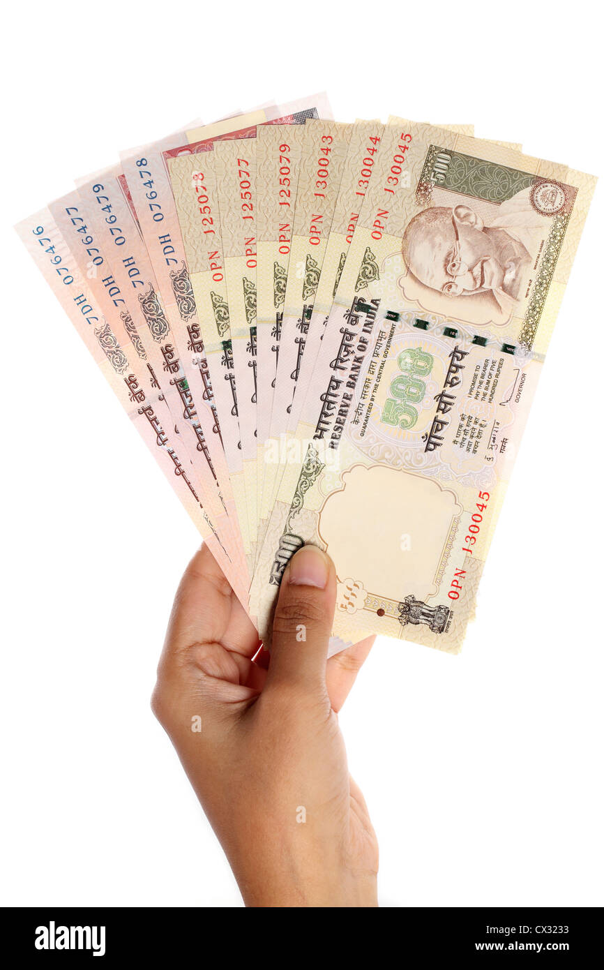 Hand with Indian five hundred and thousand rupee notes Stock Photo