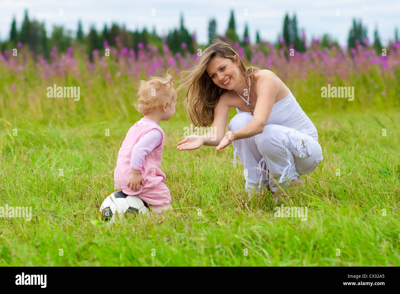Mother and daughter in meadow outdoor Stock Photo