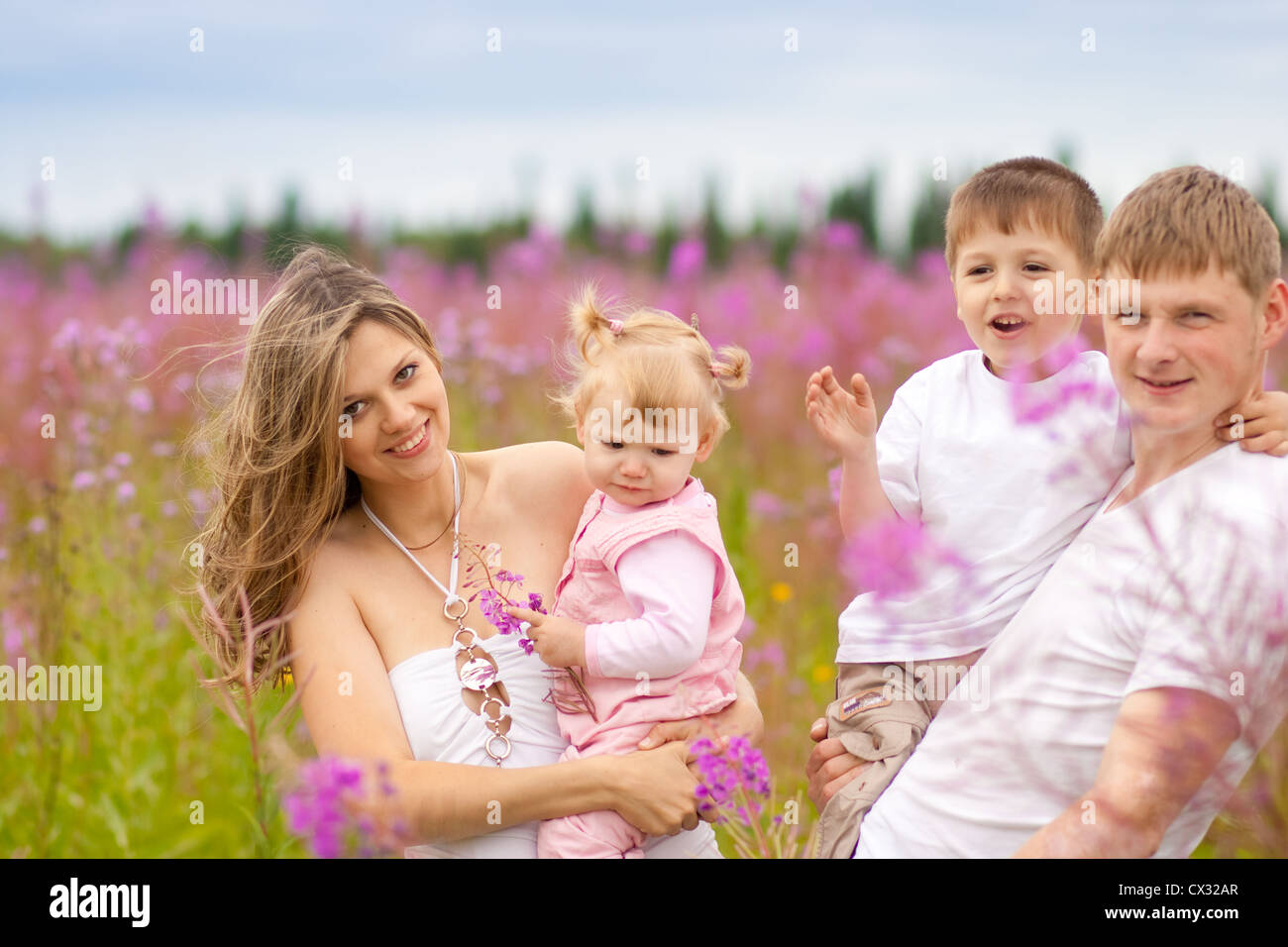 Happy family together in meadow Stock Photo