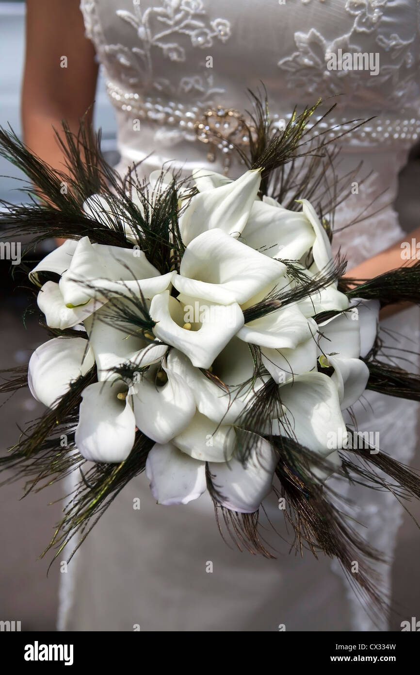 Wedding bouquet from white callas and peacock feathers Stock Photo
