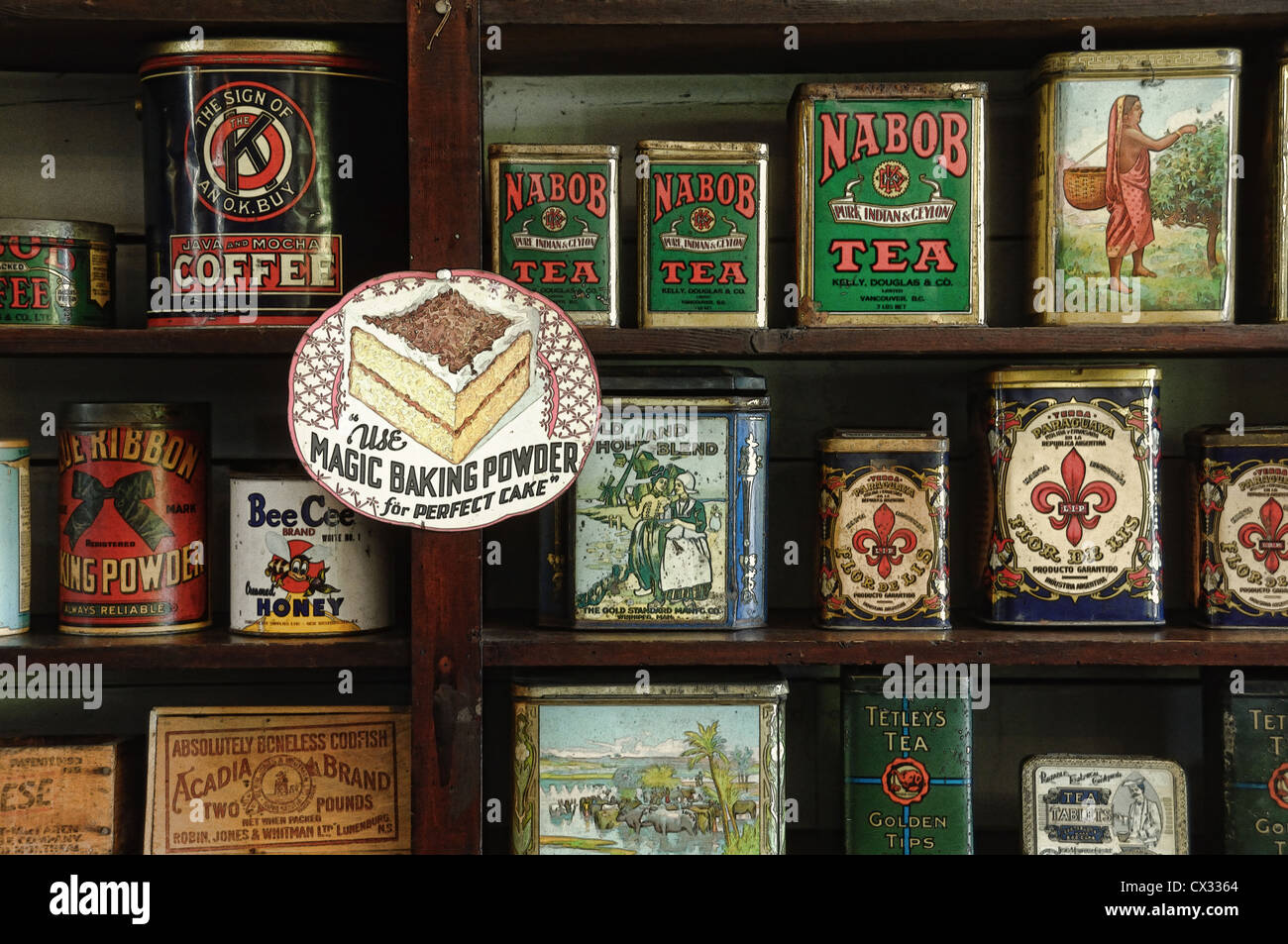 A selection of antique canned goods on a shelf in a western antique country grocery store. Stock Photo